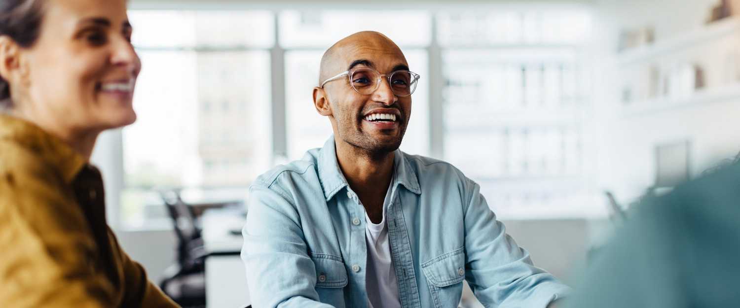 Business man sitting in a meeting with his team discussing CorVel and CERIS provider network collaboration.